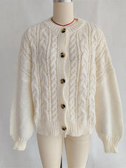 Cream-colored cable knit cardigan on a mannequin against a plain background