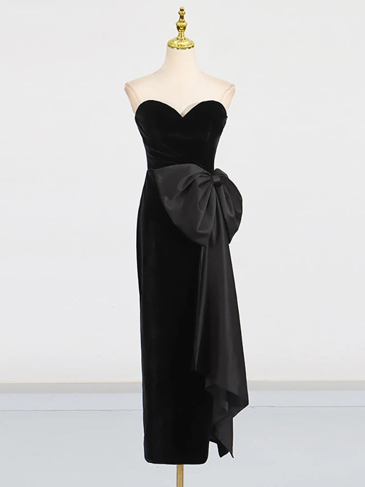 Black strapless dress with a large bow on a mannequin against a white background