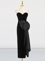 Black strapless dress with a large bow on a mannequin against a white background