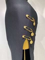 Dark gray skirt with gold safety pin embellishments on a white background