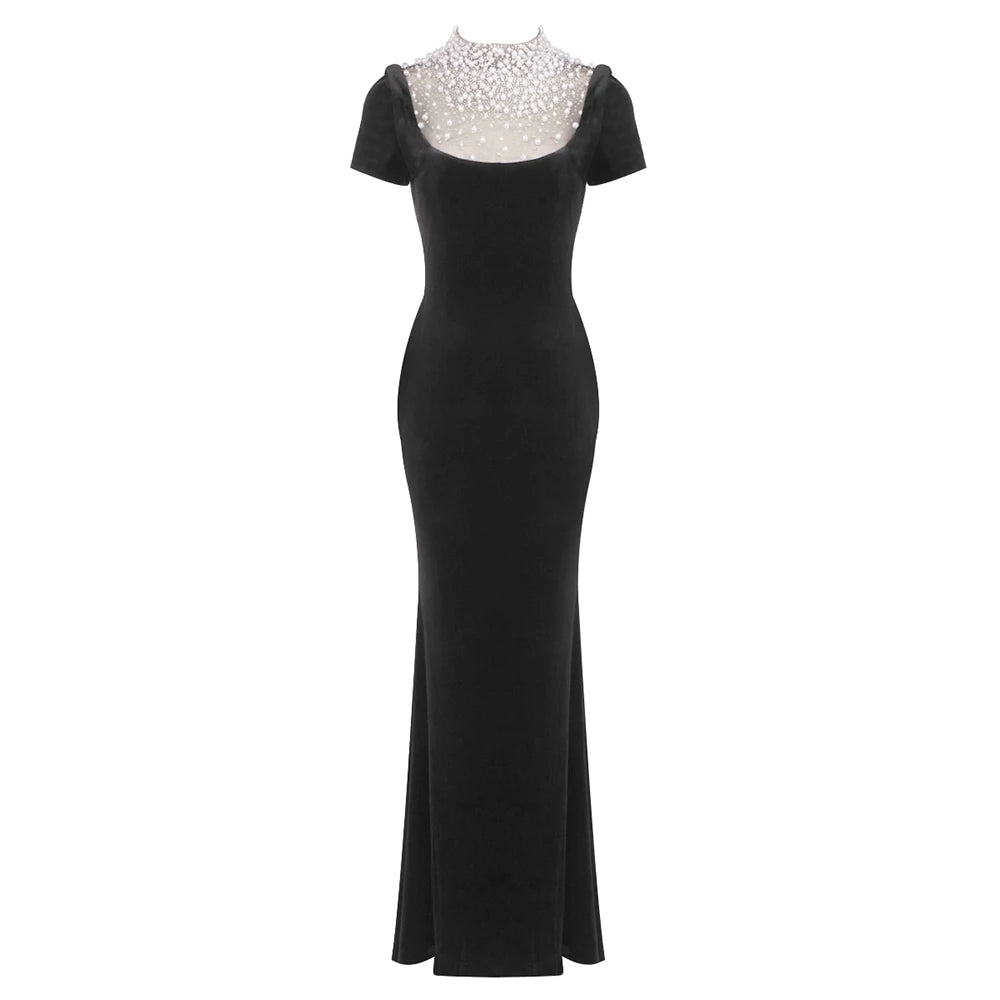 Black evening gown with silver embellishments on a white background