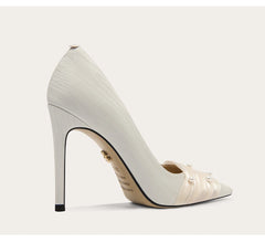 White high-heeled shoe with a pointed toe on a light gray background
