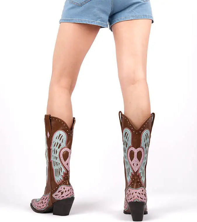 Back view of brown embroidered wing detail boots on model
