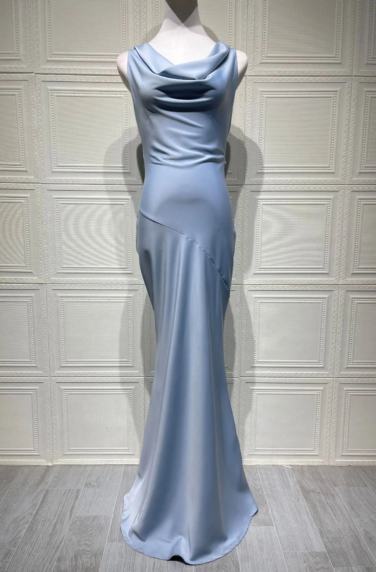 Light blue evening gown on a mannequin against a neutral background