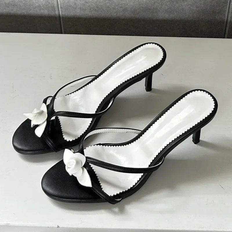 Black and white flower embellished thin heel mules