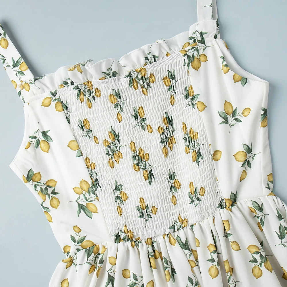 White dress with lemon print on a light gray background