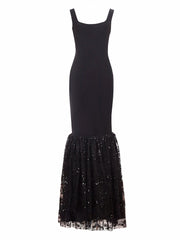 Black dress with a sequined skirt on a white background