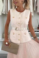Woman wearing a white sleeveless jacket with gold buttons and a beige skirt, holding a YSL handbag.