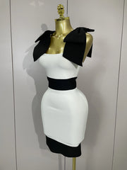 White dress with black accents on a mannequin against a white background