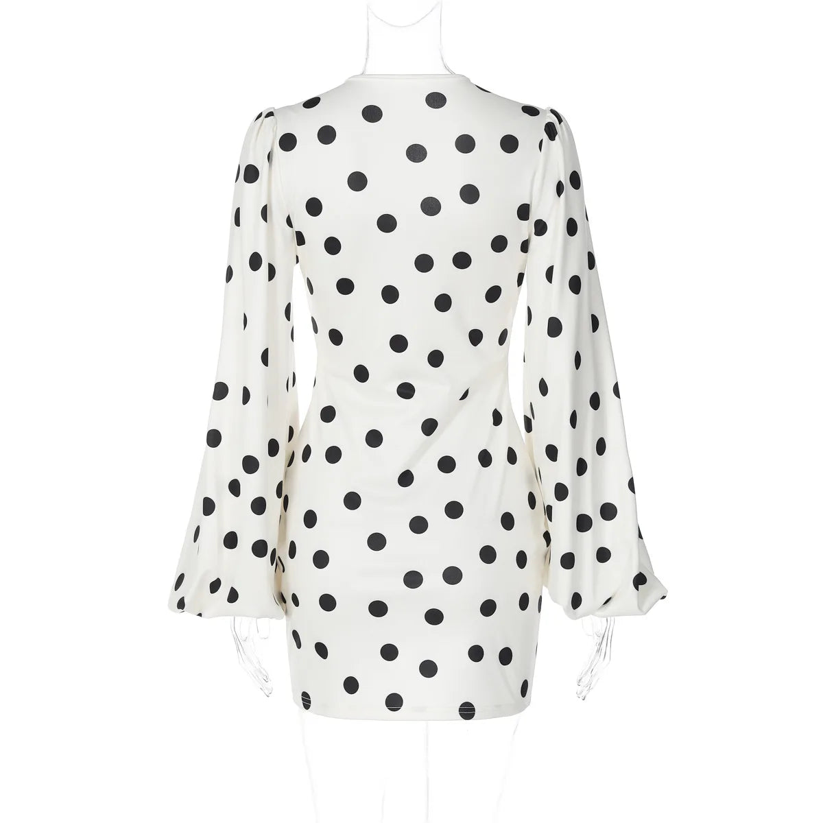 White dress with black polka dot pattern on a white background