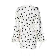 White dress with black polka dot pattern on a white background