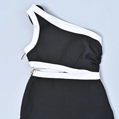 Black and white one-shoulder dress on a light gray background