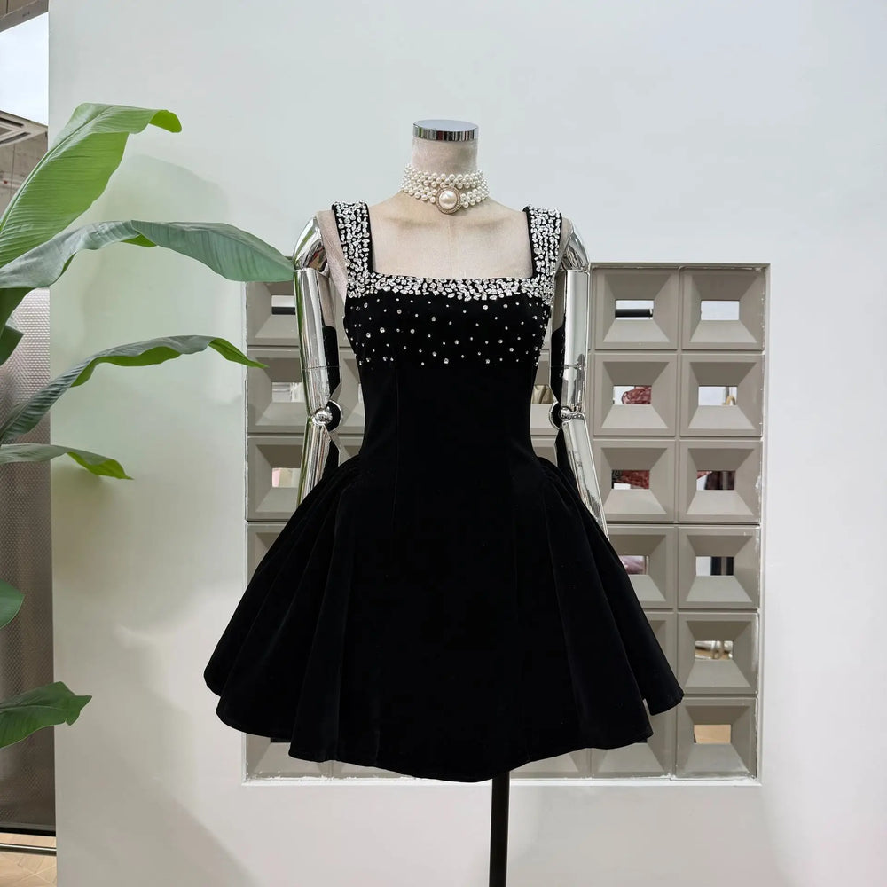 Black dress on a mannequin with a white background