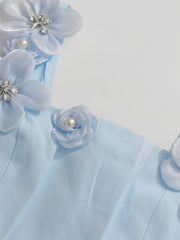 Light blue fabric with floral embellishments on a white background