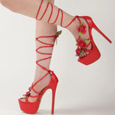 Red high-heeled shoes with floral details