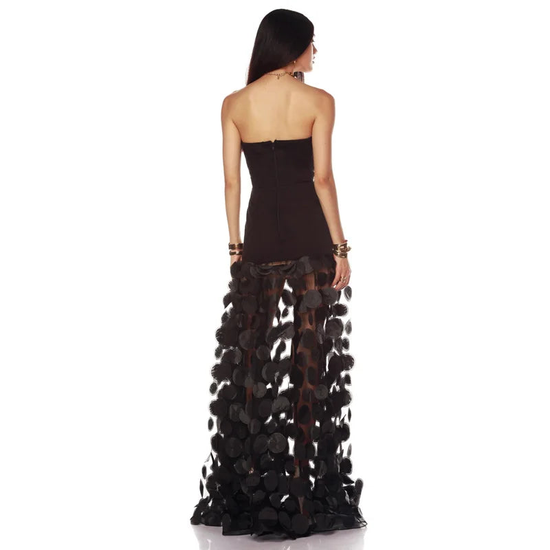 Strapless black maxi dress with dimensional floral appliques on skirt, back view