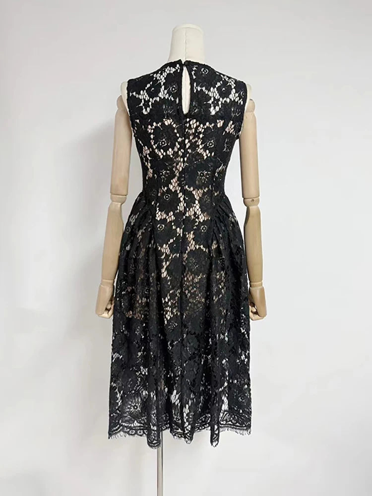 Black lace dress on a mannequin against a white background