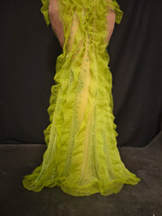 Yellow evening gown with a plunging neckline on a dark background