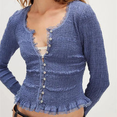 Blue textured cardigan worn by a person on a white background