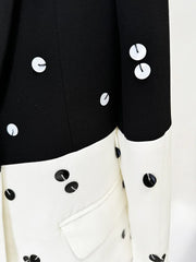 Close-up of a black and white outfit with button details