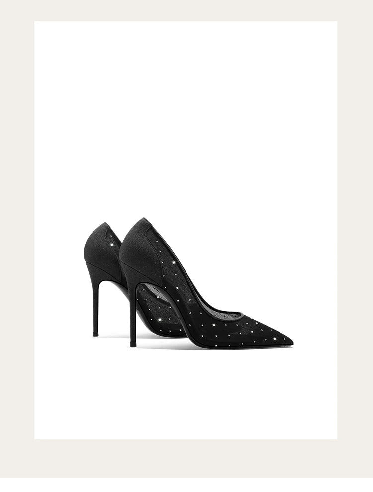 Black high-heeled shoes with studded details on a white background