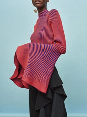 Person wearing a red and purple striped top with ruffled layers on a light blue background