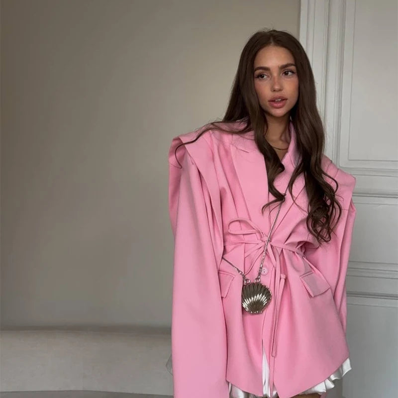 Woman wearing a pink coat with a neutral background