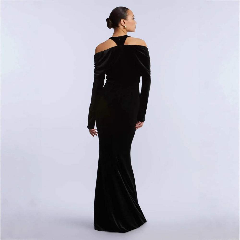 Back view of black velvet off-shoulder deep v-neck fishtail evening dress