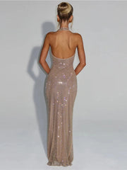 Woman wearing a sparkly, long evening gown against a plain background