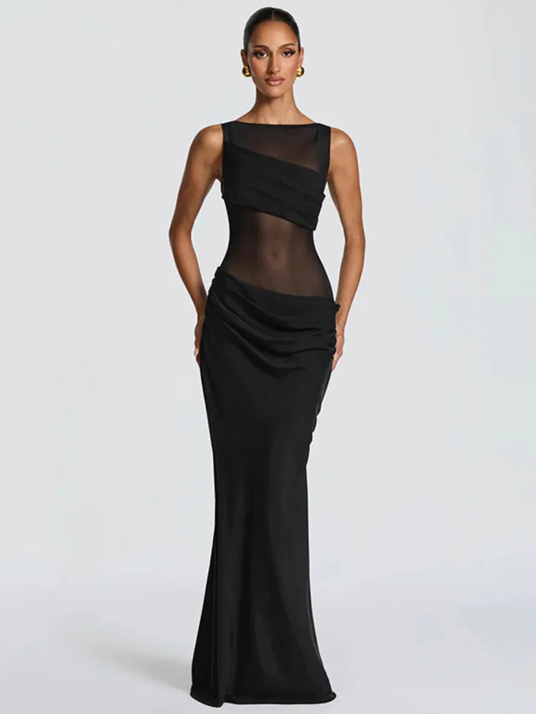 Black evening gown with sheer panels on a white background