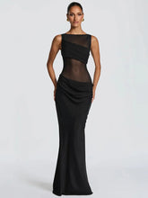 Black evening gown with sheer panels on a white background