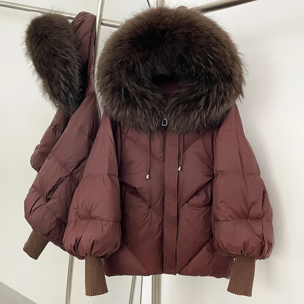 Brown puffer jacket with fur hood on a rack against a white background