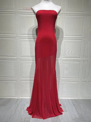 Red strapless evening gown on a mannequin against a white paneled wall.