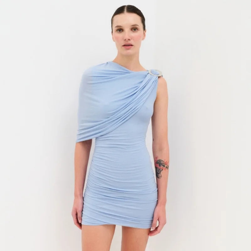 Woman wearing a light blue dress against a white background