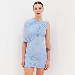 Woman wearing a light blue dress against a white background