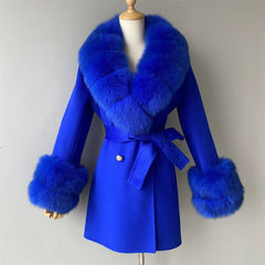 Blue coat with fur accents on a mannequin against a plain background