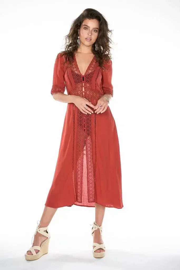 Midi dress with lace trim and V-neck, styled with wedge sandals.