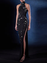 Black evening gown with star patterns on a dark background