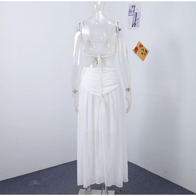 White dress on a mannequin against a plain white wall.