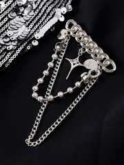 Silver chain and beaded accessory on a black background