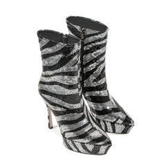 Black and silver zebra-striped high-heeled boots on a white background