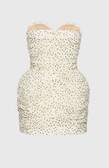 White strapless dress with black polka dot pattern on a white background