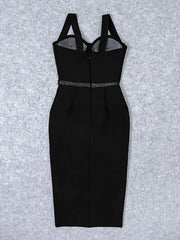 Black dress with sheer panels on a textured gray background