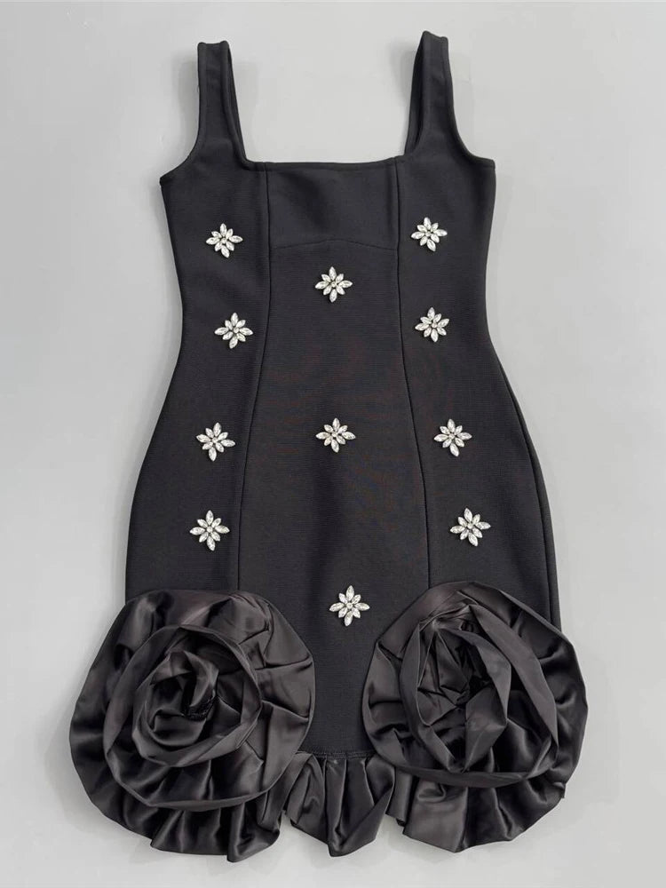 Black dress with floral embellishments on a gray background