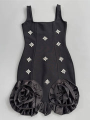 Black dress with floral embellishments on a gray background