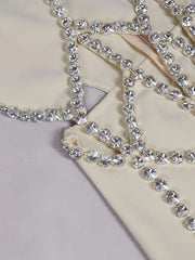 Close-up of a decorative chain with crystals on a marble surface