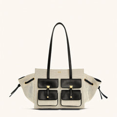 Designer handbag with black and gold accents on a white background