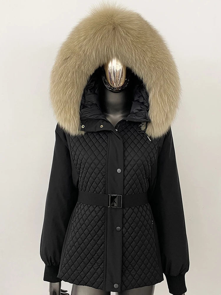 Black quilted parka with large fur hood on a mannequin against a white background