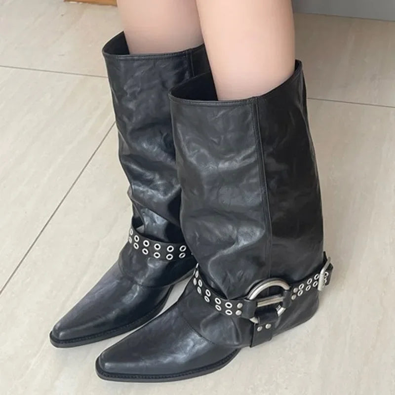 Model wearing black pointed toe ankle boots