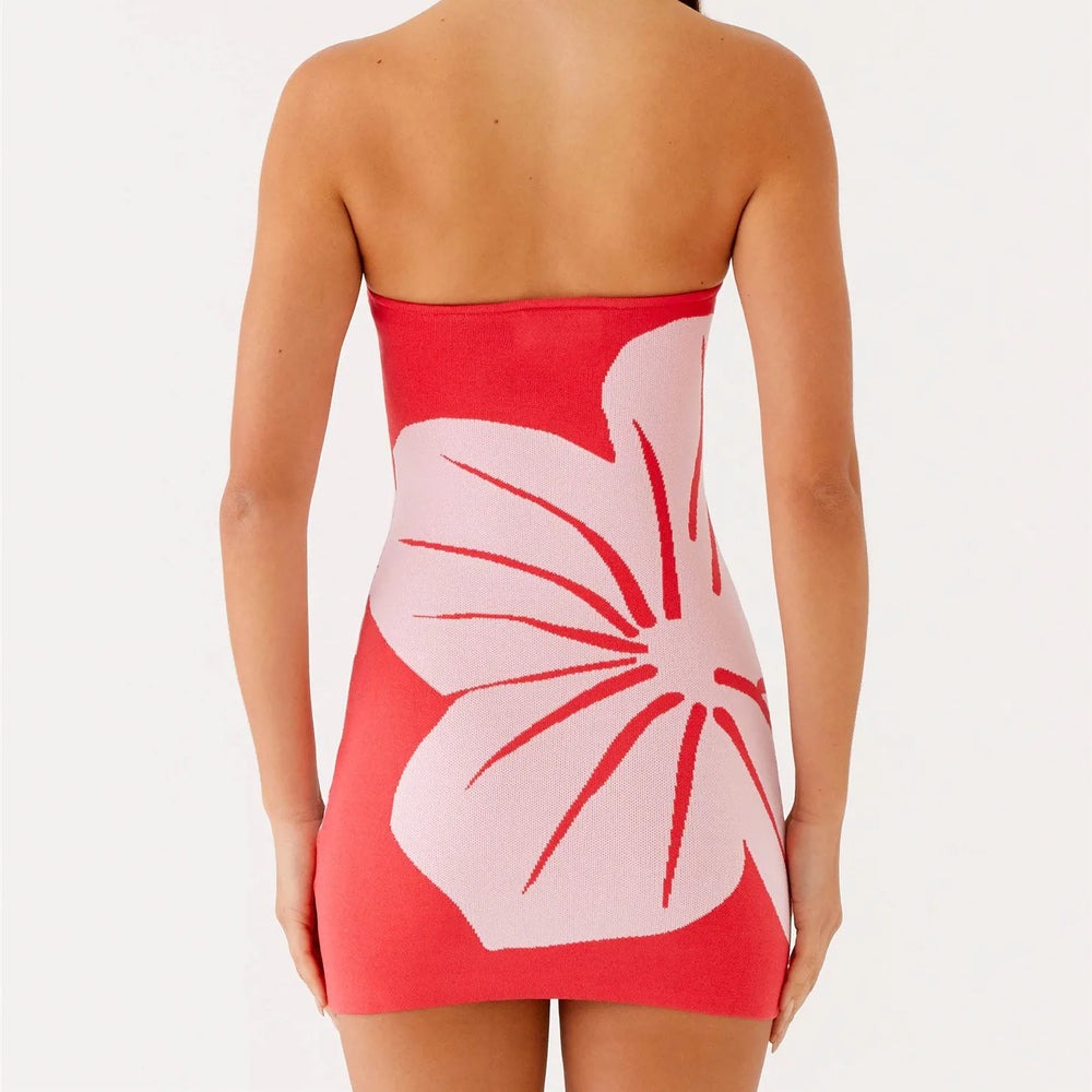 Red strapless dress with a large pink floral design on a white background